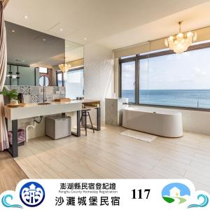 a large bathroom with a tub and a table at Beachcastle & Sea View Villa in Magong
