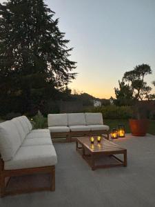 a patio with two couches and a coffee table at Casa da Regadinha in Muxagata +30 photos