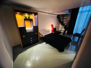 a small room with a bed and a mirror at Parthenope b&b in Naples
