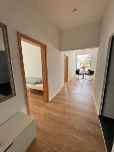 a room with a hallway with a bed and a mirror at 2 Bedroom Apartment at Grenzach train station in Grenzach-Wyhlen