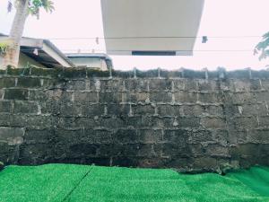 a brick retaining wall with green grass at BUDGET Homestay RumahTamu TELIPOT Kota Bharu in Kota Bharu