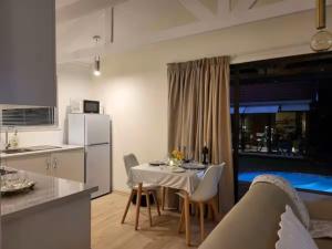 a kitchen and a dining room with a table and a kitchen at African Diamond - Date Night Suite in Benoni