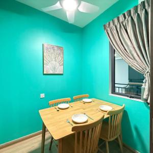 a dining room with a wooden table and chairs at Regalia Park 2B1R 6pax Condo Forest City in Gelang Patah