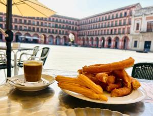 a plate of food with french fries and a cup of coffee at La Casa de Claudio Marcelo in Córdoba