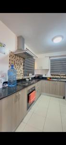 a large kitchen with a stove top oven at Madaraka 1 Westpointe in Nairobi