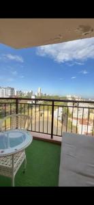a balcony with a table and a view of the city at Madaraka 1 Westpointe in Nairobi +9 photos