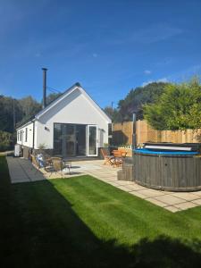 a backyard with a house and a swimming pool at Vine Cottage in Westfield