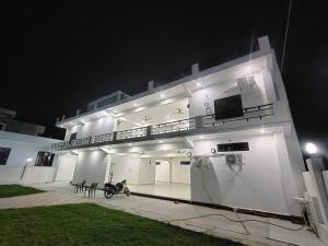 a building with a motorcycle parked in front of it at night at ANAND BHAWAN Aj in Varanasi +12 photos
