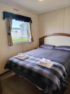 Ένα ή περισσότερα κρεβάτια σε δωμάτιο στο The Willow Caravan Holiday Home