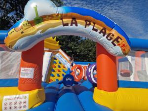 an inflatable water park with a water slide at Camping le Clos de Balleroy in Balleroy +100 photos