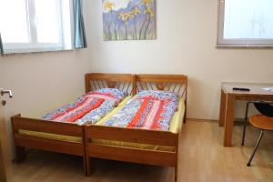 a bed with two pillows on it in a room at Großzügige Souterrainzimmer in Munich