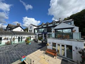 a large house with a patio in front of it at Ambleside Rooms & Suites in Ambleside
