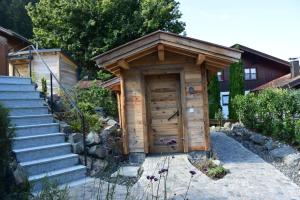a wooden out house with a set of stairs at Alpinum Chalet mit privater Außensauna in Rettenberg