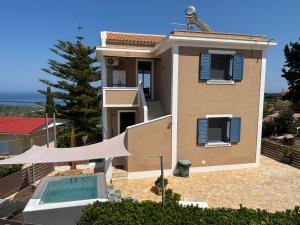 a house with a swimming pool in front of it at Villa Thea - Τhe View 1st floor in Áno Yerakaríon +12 photos