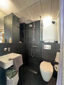 a bathroom with a sink and a toilet and a shower at zons22 I TheTinySpace Architekten Apartment im Denkmal in Dormagen