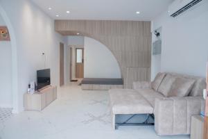 a living room with a couch and a tv at Be House 5 SongKhla in Songkhla