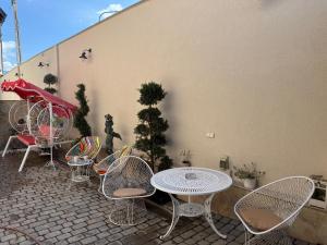 a group of chairs and tables on a patio at Antique Charm Home SPA&FUN in Râşnov