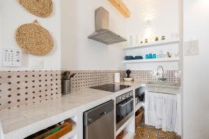 a kitchen with white walls and a counter top at Casa Al-Janda in Barbate