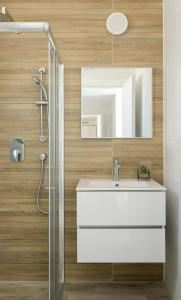 a bathroom with a white sink and a mirror at 3BR charming on the 14th floor overlooking the sea in Qiryat Yam