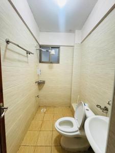 a bathroom with a toilet and a sink at Skyhorse condo in Nairobi