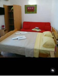 a bed with two utensils sitting on top of it at Montenegrina in Budva +1 photo