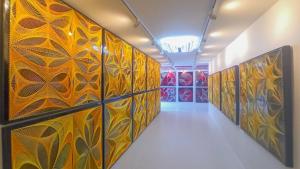 a hallway with colorful art on the walls at Art by Yui House in Ban Tha Maprang