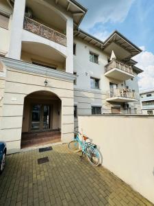 a bike parked in front of a building at SHoliday La Parter cu Parcare Privată și Spațiu Modern in Dumbrăviţa +47 photos