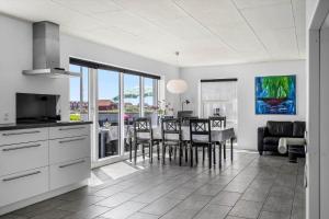 a kitchen and dining room with a table and chairs at 70372-Ulfborg-Skolegade-6 in Thorsminde +23 photos