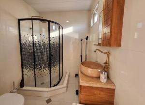 a bathroom with a shower and a wooden sink at Sighnaghi Art Hotel in Sighnaghi +31 photos