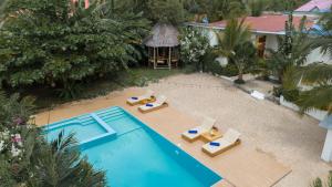 an overhead view of a swimming pool with lounge chairs at BT Seaside Cottages in Mkunguni