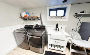 a laundry room with a washer and a sink at Vernal Sport-Court Base Camp in Vernal