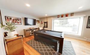a living room with a pool table and a television at Vernal Sport-Court Base Camp in Vernal +16 photos