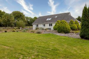 a white house with a lawn and trees at Fernfeild in Old Twopothouse Cross Roads