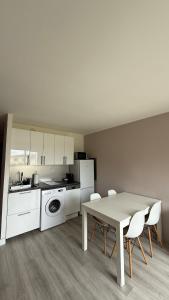 a kitchen with a table and chairs in a room at Simple one bedroom apt with pool and tennis at the entrance of Saint Tropez in Saint-Tropez