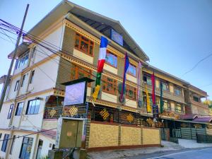 a building with colorful flags on the side of it at The Valley Vista Resort Gangtok with Mountain View in Gangtok