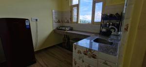 a kitchen with a sink and a counter top at Nitin Home Stay in Rewalsar