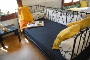 a bed with a book sitting on top of it at Estudio La Tienda de Adanero in Adanero