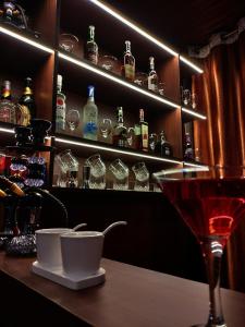 a bar with a martini glass and a shelf of alcohol at The Valley Vista Resort Gangtok with Mountain View in Gangtok