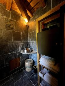 a bathroom with a sink in a stone wall at Bergerie in Volpajola +10 photos