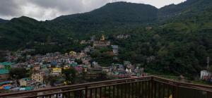 a view of a town on a hill with mountains at Nitin Home Stay in Rewalsar +4 photos