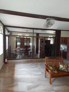 a living room with a couch and a dining room at Trishuri's Guest House in Puerto Princesa City +8 photos