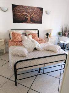 a bed with pillows on it in a room at Villa Nanou Riviera in Nice