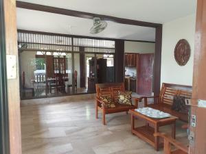 a living room with two chairs and a table at Trishuri's Guest House in Puerto Princesa City