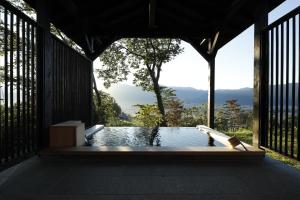 a plunge pool with a view of the mountains at Satoyama-Jujo The House IZUMI in Minami Uonuma