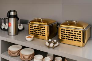 a kitchen with two baskets and plates on a shelf at The Elysian Boutique Stays - Havelock in Havelock Island