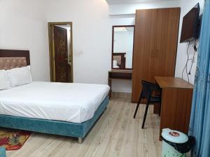 a hotel room with a bed and a desk and a desk at Hotel D Palace in Dhaka +11 photos
