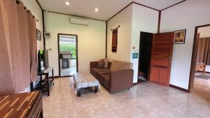 a living room with a couch and a table at Serenity1 Homestay in Chiang Dao