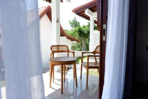 a table and two chairs on a porch at Ginantary Cottages in Uluwatu