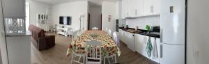 a kitchen and a dining room with a table in a room at Boa Passagem AL in Bicas