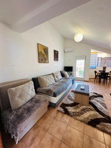 a living room with a couch and a table at House of peace in Podgorica +30 photos